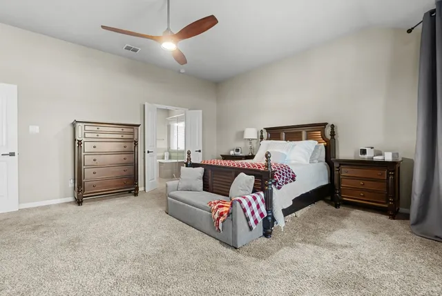 a bedroom with furniture and a ceiling fan