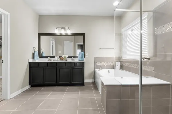 a bathroom with a sink a mirror and a bathtub