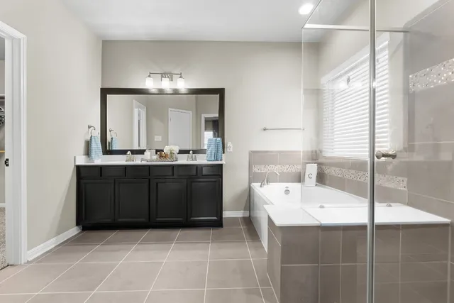 a bathroom with a sink a mirror and a bathtub