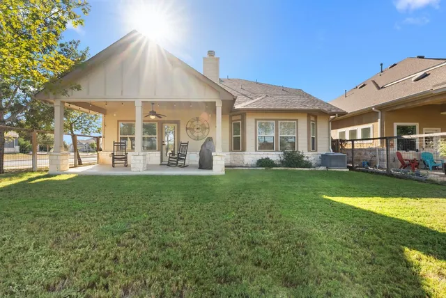 a view of a house with a backyard and a patio