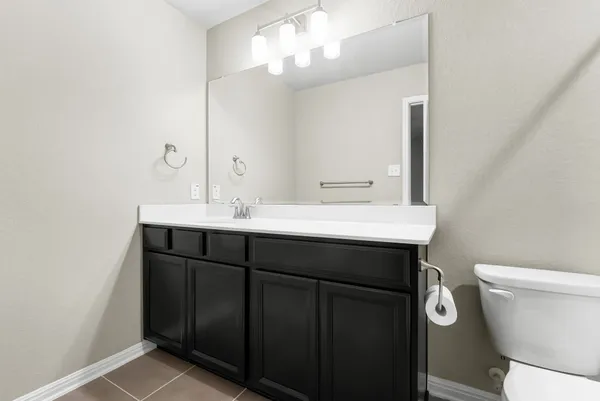 a bathroom with a shower a toilet and a sink