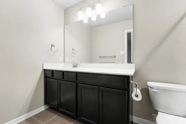 a bathroom with a shower a toilet and a sink