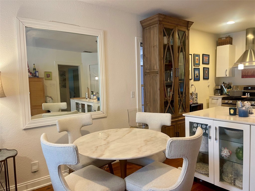 406 East Monroe Street, Unit A Austin, TX 78704 - Photo 12 of 35 a dining room with furniture and a large mirror
