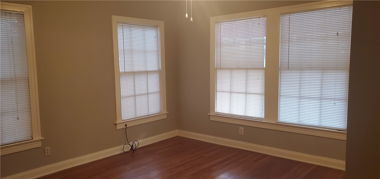 406 East Monroe Street, Unit A Austin, TX 78704 - Photo 26 of 35 an empty room with wooden floor and windows