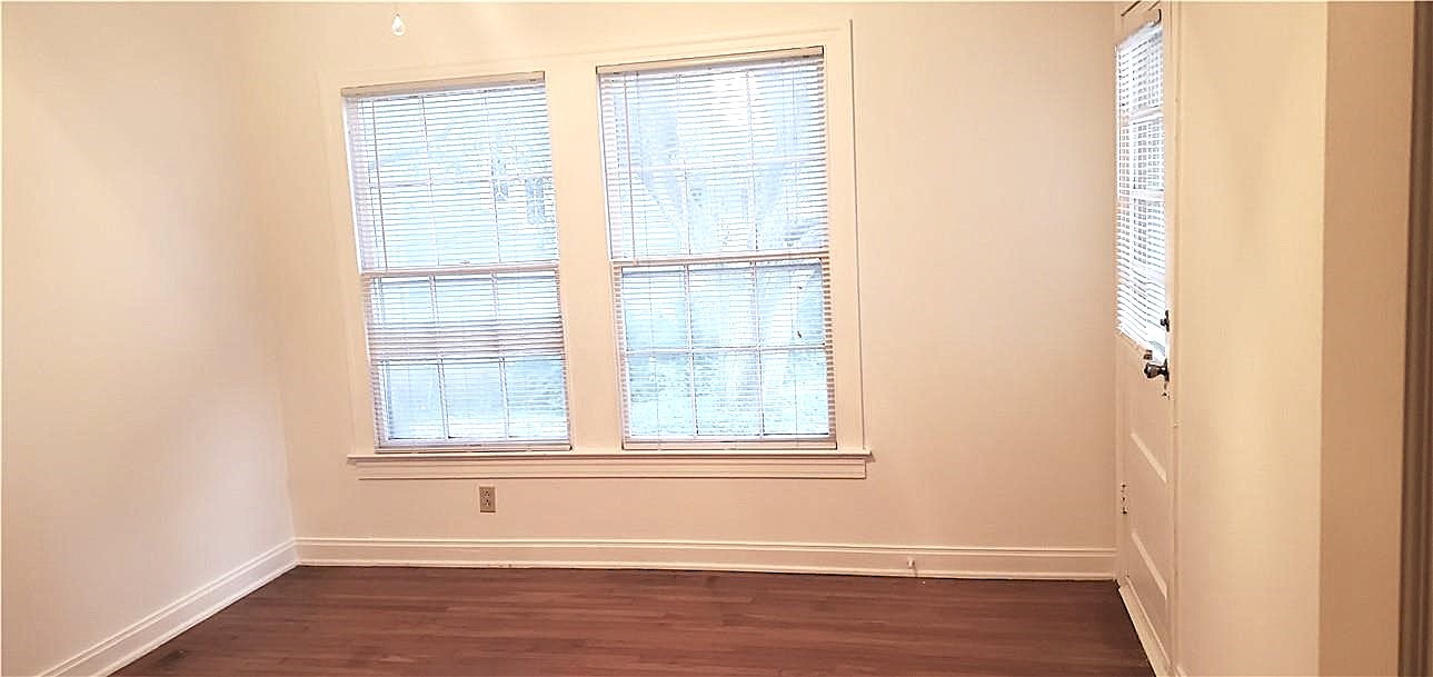 406 East Monroe Street, Unit A Austin, TX 78704 - Photo 31 of 35 an empty room with wooden floor and windows