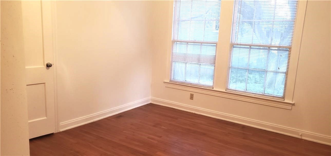 406 East Monroe Street, Unit A Austin, TX 78704 - Photo 32 of 35 a view of an empty room with wooden floor and a window