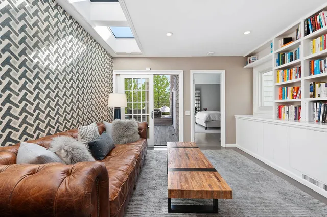 a living room with furniture and a book shelf