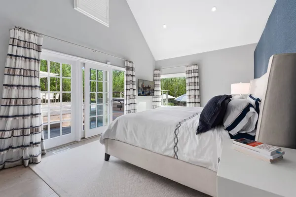 a bedroom with a bed and large window