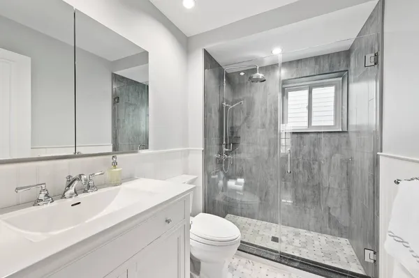 a bathroom with a sink toilet and shower