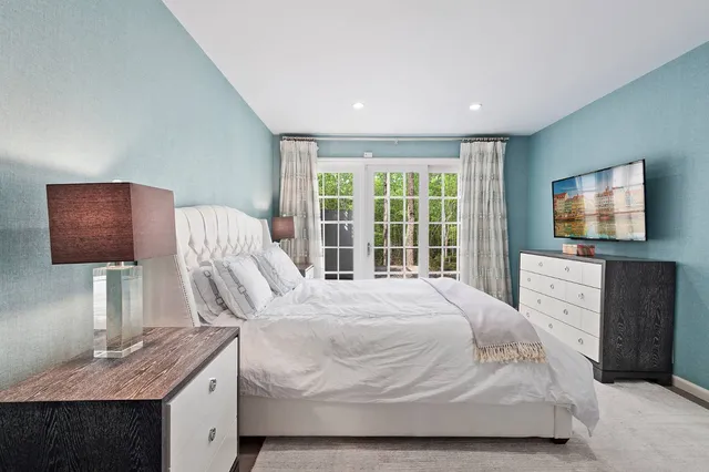 a bedroom with a bed and a flat screen tv