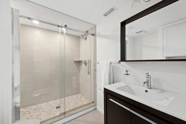 a view of a bathroom with a sink and mirror