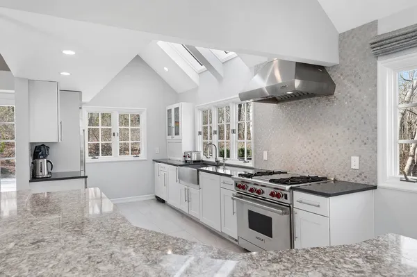 a kitchen with stainless steel appliances granite countertop a stove and a sink