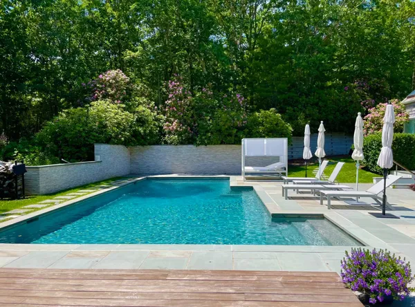 a view of a chairs and table in the backyard