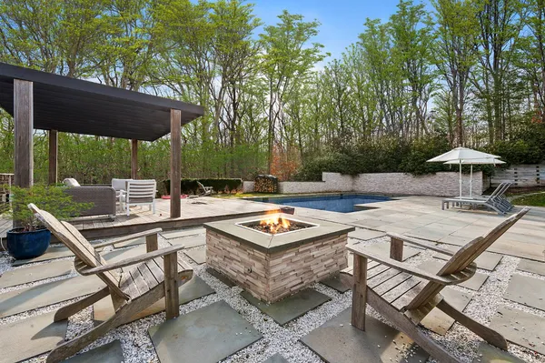 a backyard of a house with table and chairs