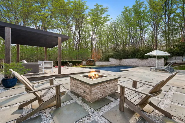 a backyard of a house with table and chairs