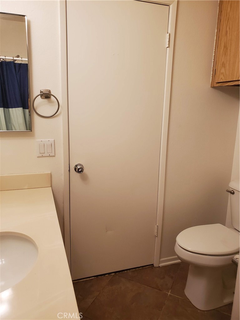 7864 Portola Road Rancho Cucamonga, CA 91730 - Photo 11 of 37 a white toilet sitting next to a shower