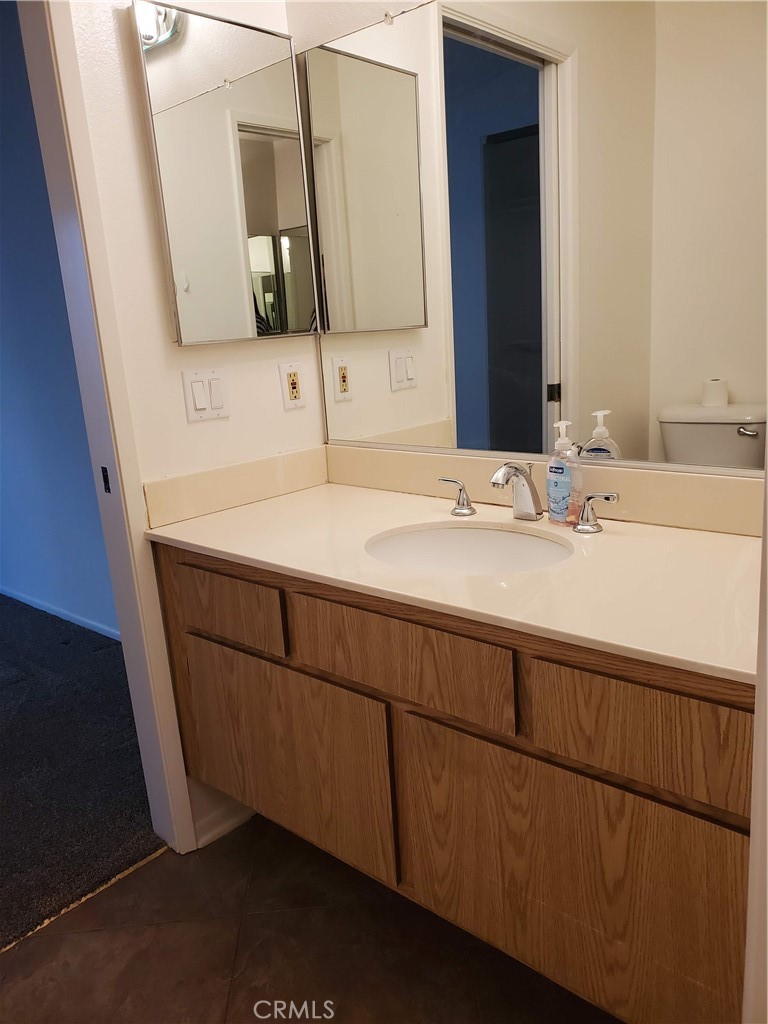 7864 Portola Road Rancho Cucamonga, CA 91730 - Photo 12 of 37 a bathroom with a sink and a mirror