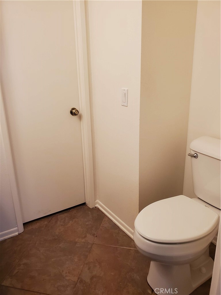 7864 Portola Road Rancho Cucamonga, CA 91730 - Photo 13 of 37 a white toilet sitting next to a shower