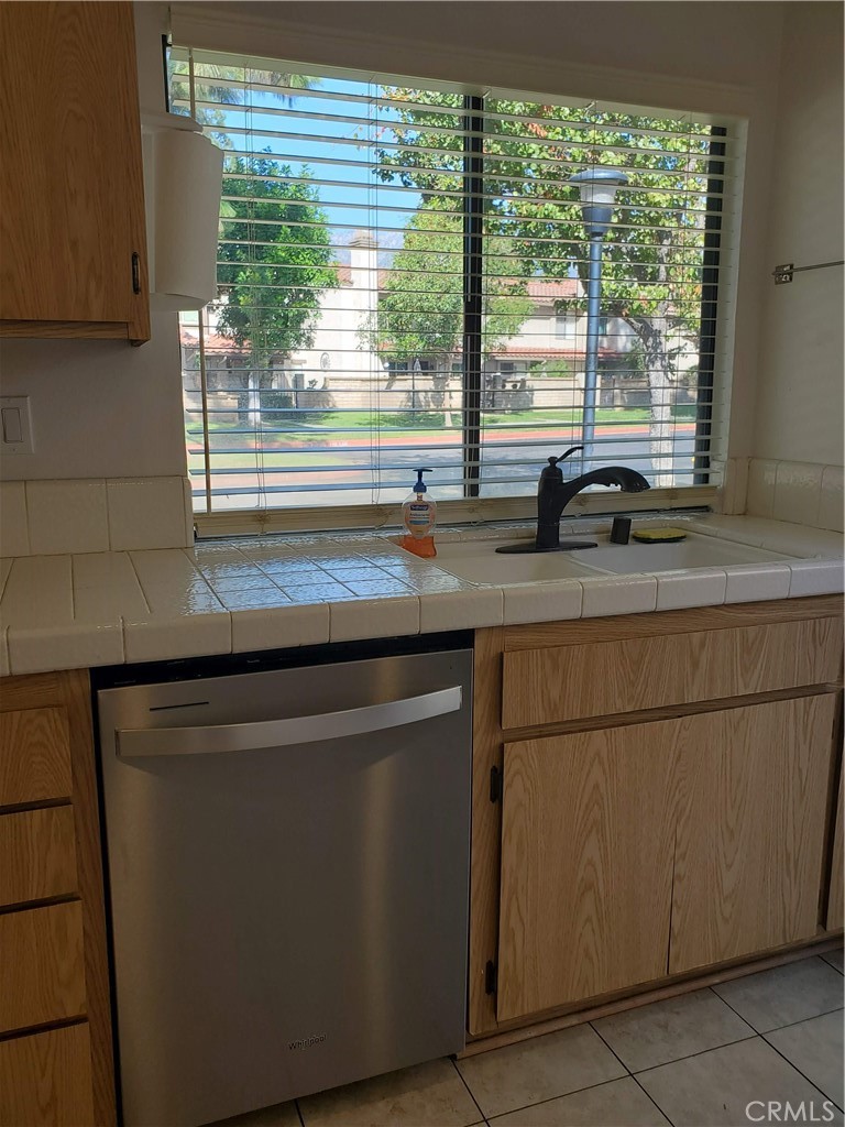 7864 Portola Road Rancho Cucamonga, CA 91730 - Photo 22 of 37 a kitchen with a window and a sink