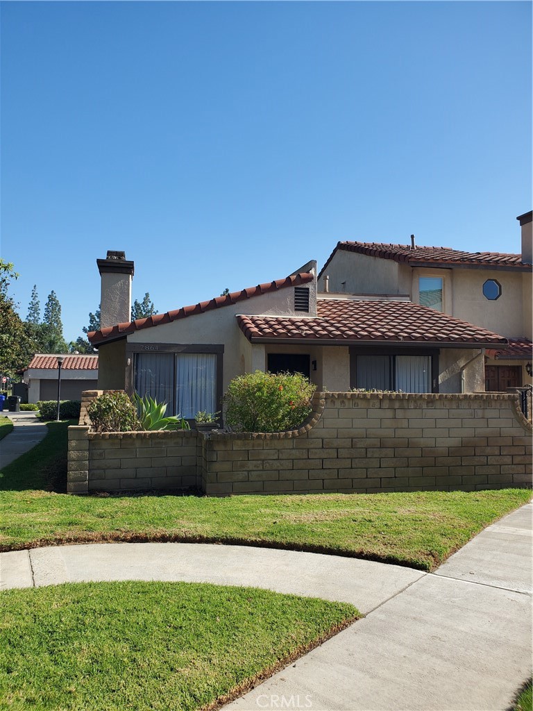 7864 Portola Road Rancho Cucamonga, CA 91730 - Photo 30 of 37 a front view of a house with a yard