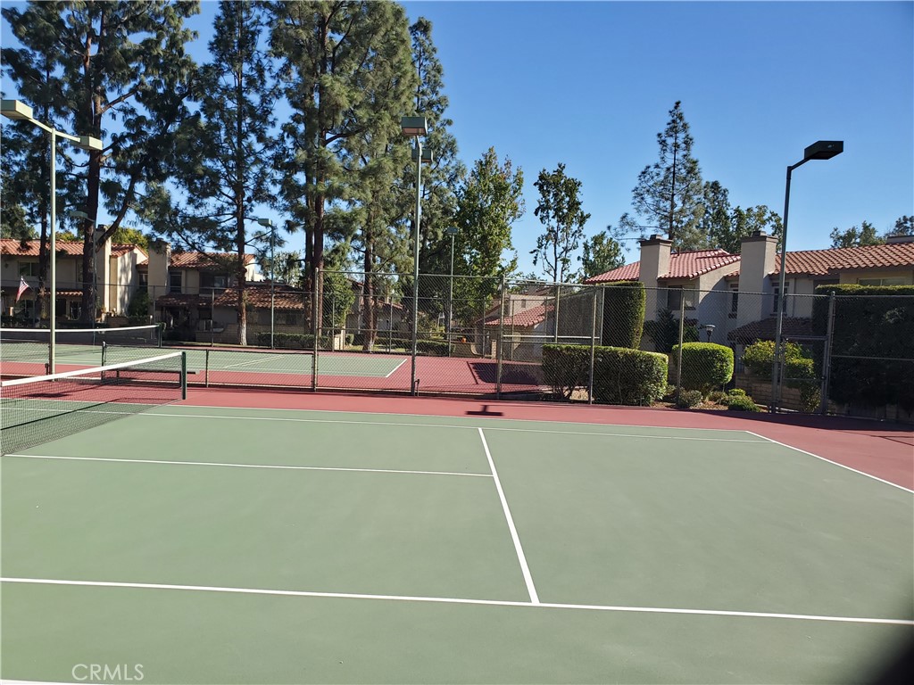 7864 Portola Road Rancho Cucamonga, CA 91730 - Photo 32 of 37 a view of a tennis ground with large trees