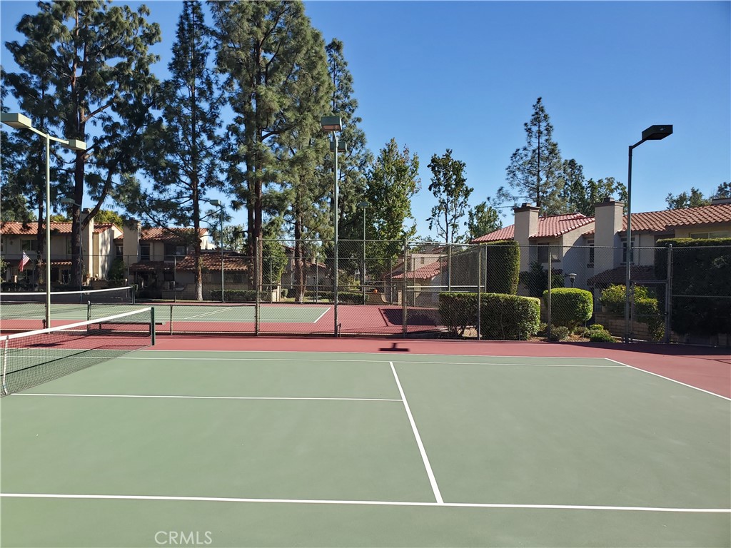 7864 Portola Road Rancho Cucamonga, CA 91730 - Photo 33 of 37 a view of a tennis ground with large trees