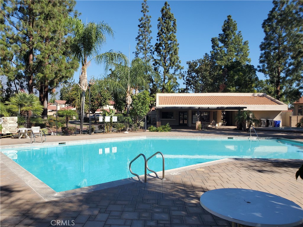 7864 Portola Road Rancho Cucamonga, CA 91730 - Photo 34 of 37 a view of a house with swimming pool and yard