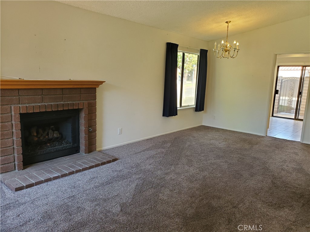 7864 Portola Road Rancho Cucamonga, CA 91730 - Photo 5 of 37 an empty room with windows and fireplace