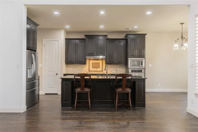 a kitchen with a table and chairs in it