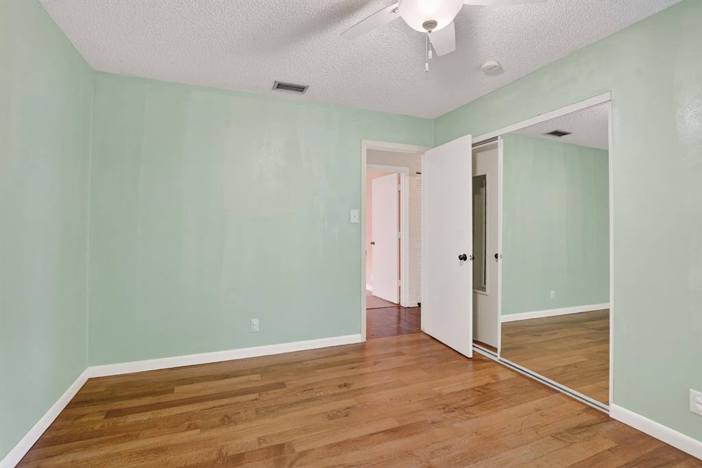 501 Northwest 54th Street Boca Raton, FL 33487 - Photo 29 of 43 a view of empty room with wooden floor and fan