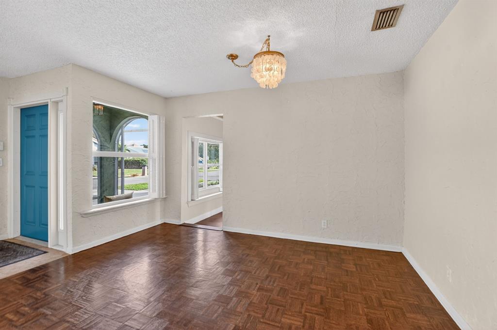 501 Northwest 54th Street Boca Raton, FL 33487 - Photo 10 of 43 an empty room with wooden floor and windows