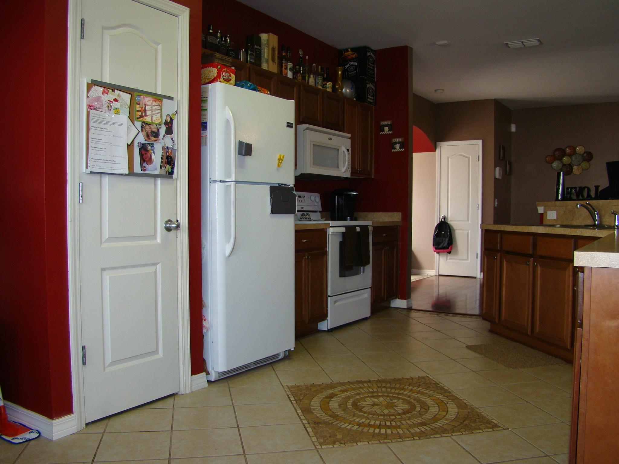 607 Prairie Street Crestview, FL 32536 - Photo 14 of 43 a kitchen with stainless steel appliances granite countertop a refrigerator a stove top oven and a sink