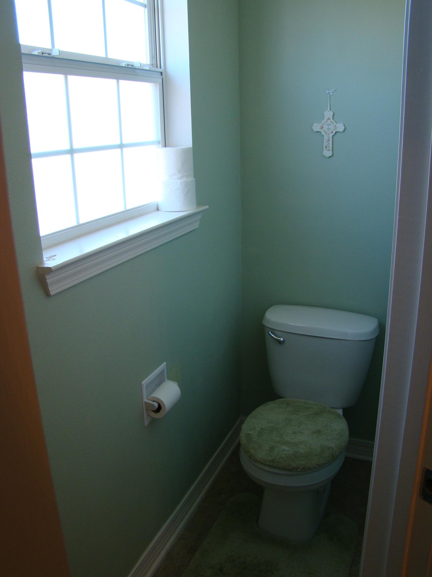 607 Prairie Street Crestview, FL 32536 - Photo 25 of 43 a white toilet sitting in a bathroom next to a window