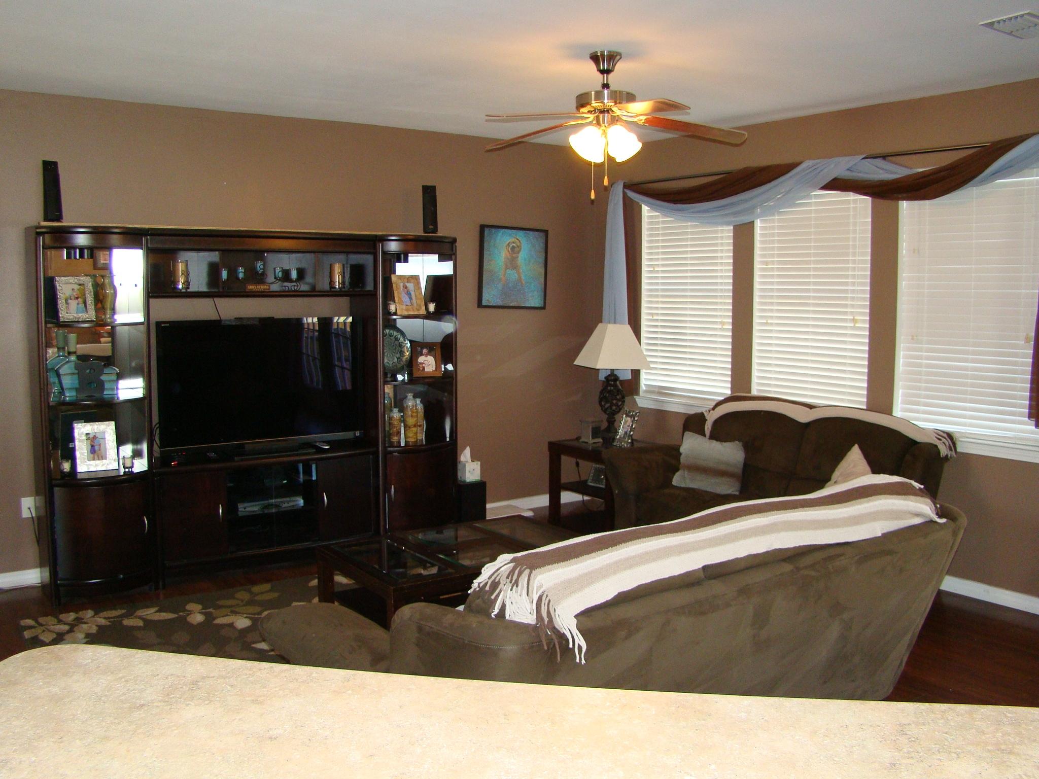 607 Prairie Street Crestview, FL 32536 - Photo 10 of 43 a living room with furniture a flat screen tv and a window