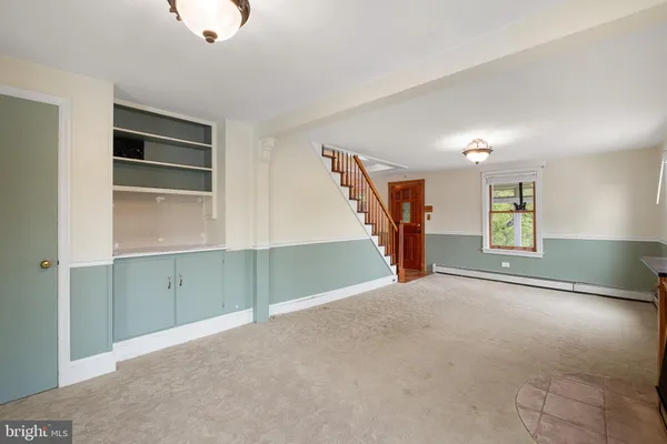 a view of empty room with wooden floor and window