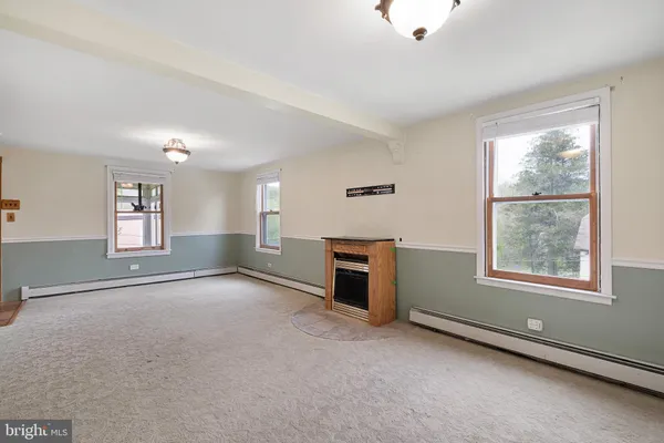 an empty room with windows and closet