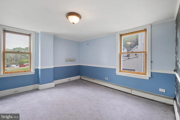 an empty room with windows and closet