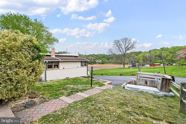 a view of a house with a big yard and potted plants