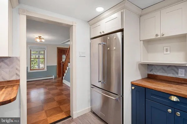 a kitchen with stainless steel appliances granite countertop a refrigerator and a stove