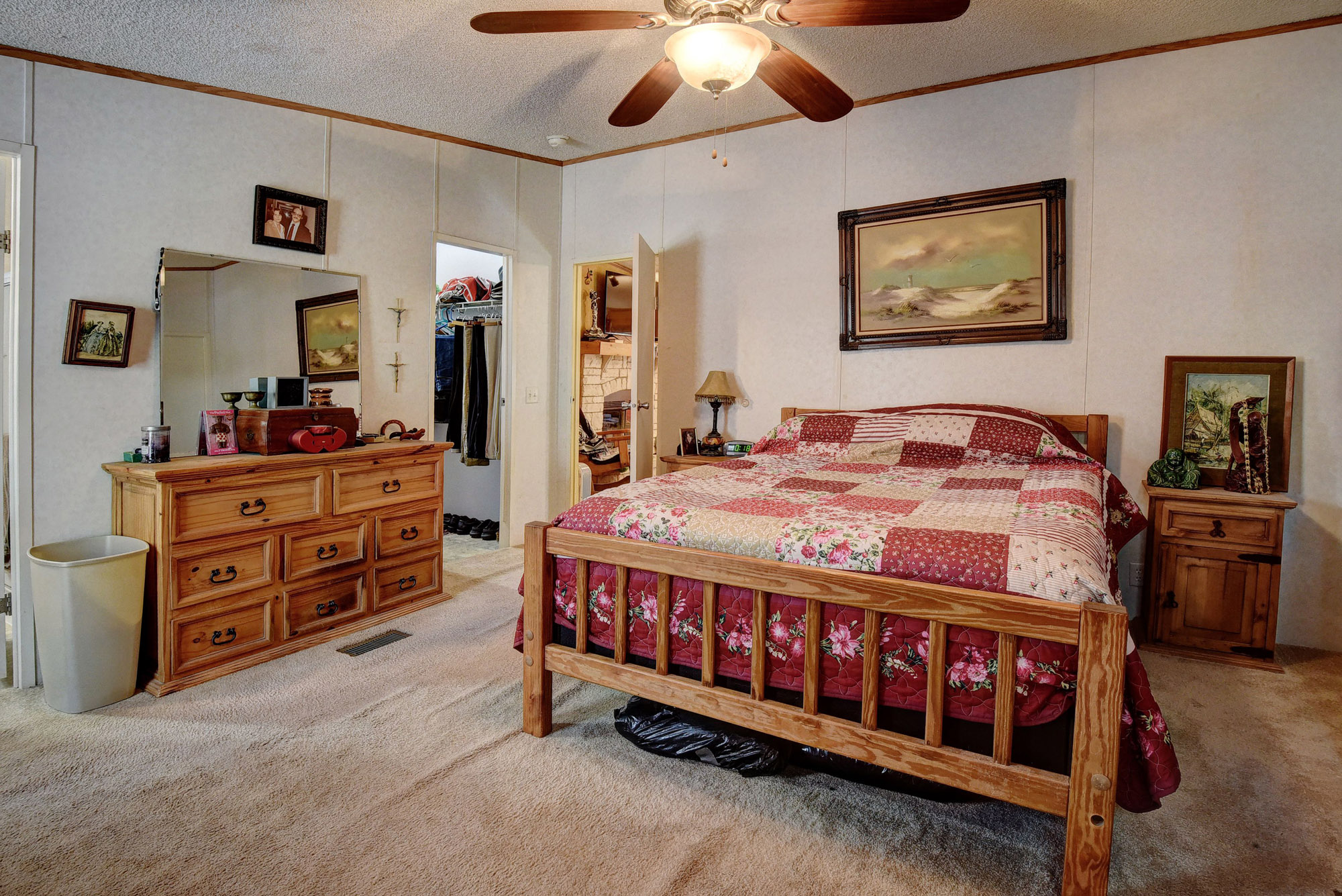 181 Lockwood Road Red Rock, TX 78662 - Photo 16 of 32 a bedroom with a bed and a chandelier