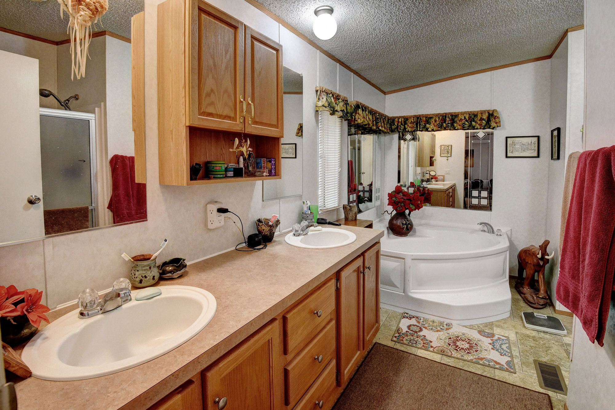181 Lockwood Road Red Rock, TX 78662 - Photo 18 of 32 a bathroom with a sink double vanity and a mirror