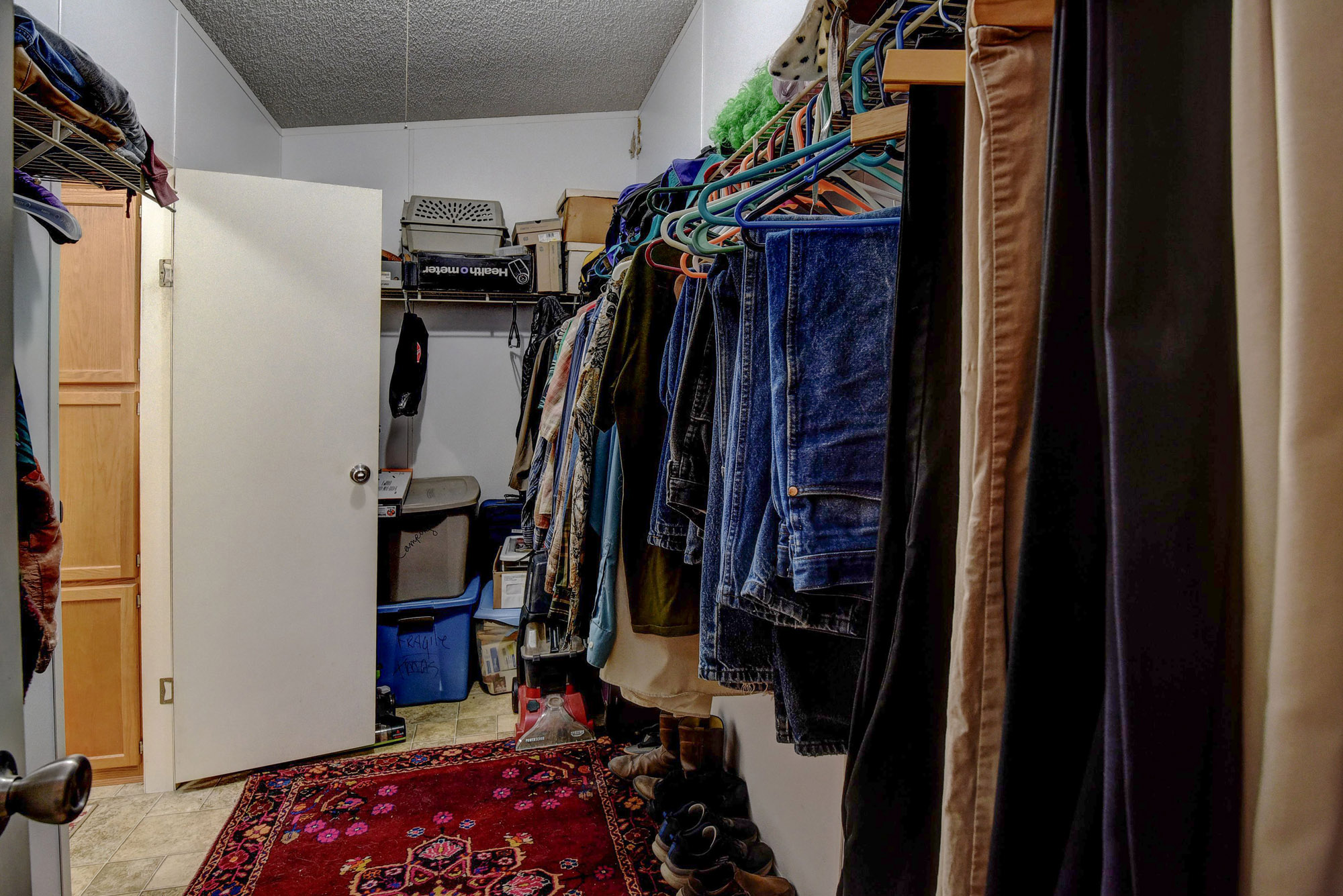 181 Lockwood Road Red Rock, TX 78662 - Photo 19 of 32 a view of walk in closet with clothes and shoes