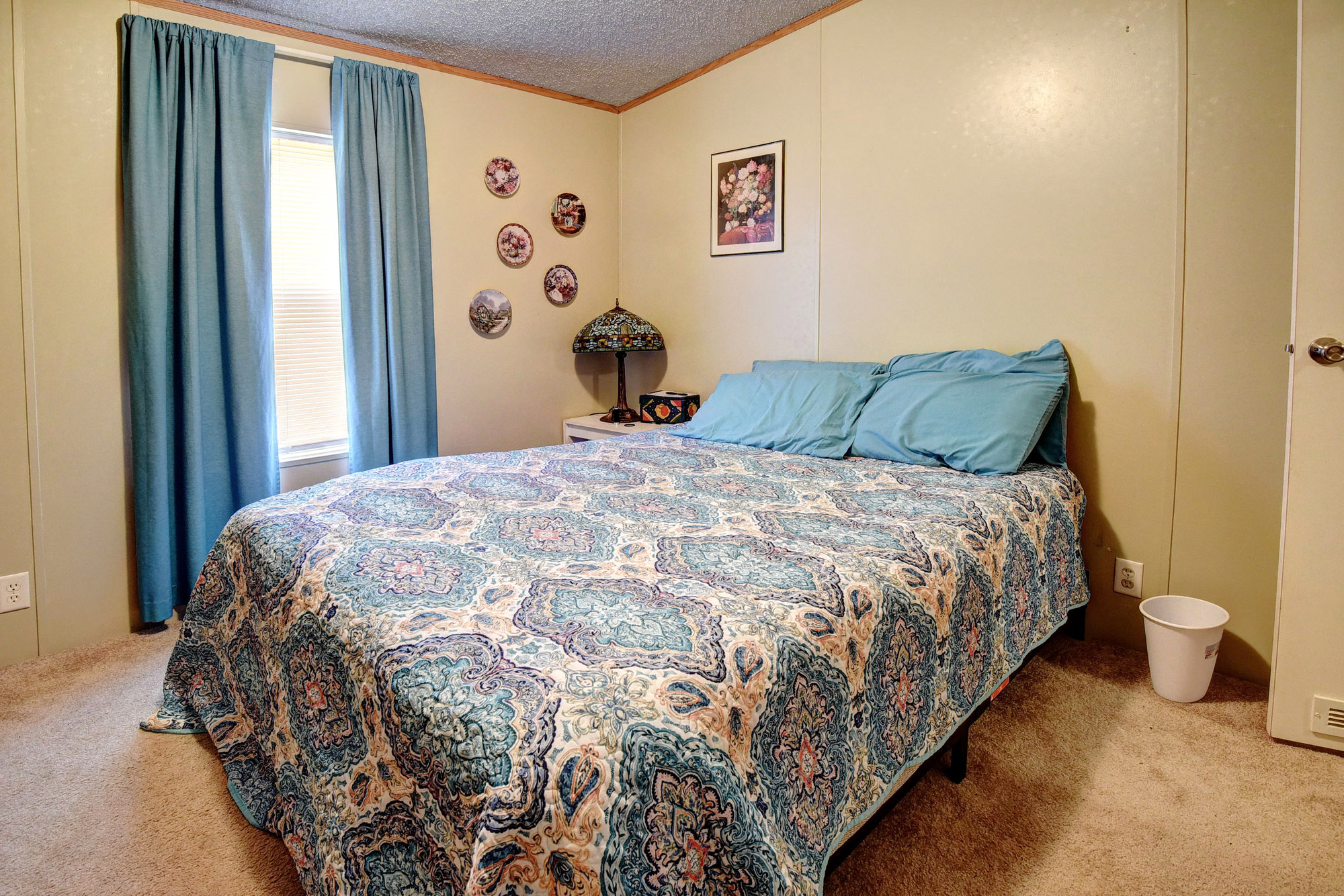 181 Lockwood Road Red Rock, TX 78662 - Photo 22 of 32 a large bed sitting in a bedroom next to a bathroom next to a window
