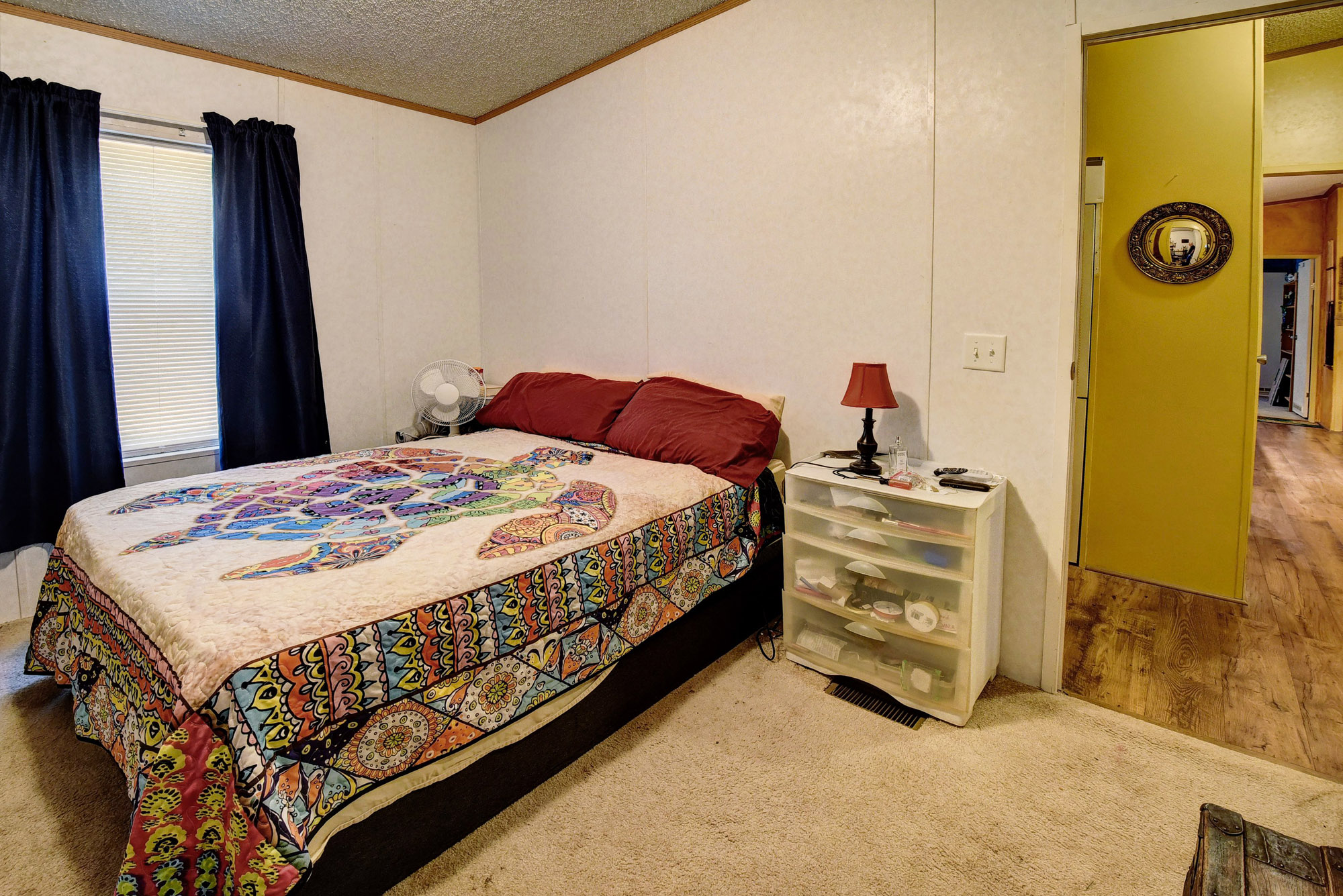 181 Lockwood Road Red Rock, TX 78662 - Photo 23 of 32 a bedroom with a bed and a mirror