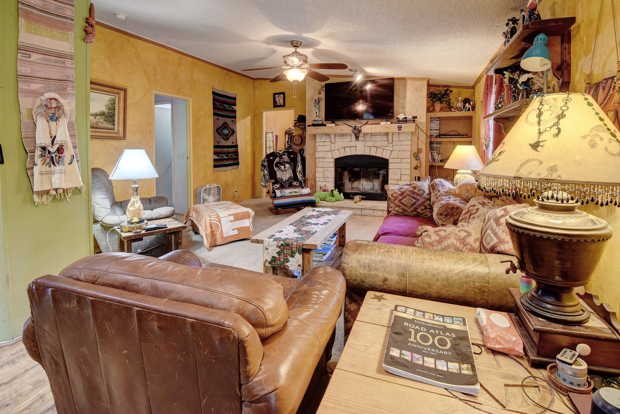 181 Lockwood Road Red Rock, TX 78662 - Photo 7 of 32 a living room with furniture a flat screen tv and a fireplace