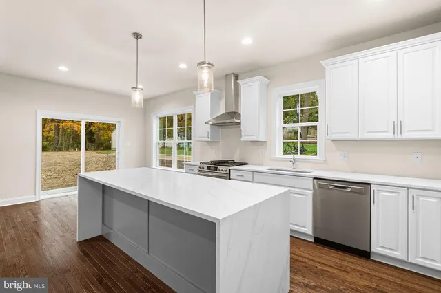 a kitchen with stainless steel appliances sink stove and cabinets