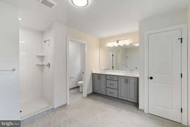 a bathroom with a toilet a sink and a mirror