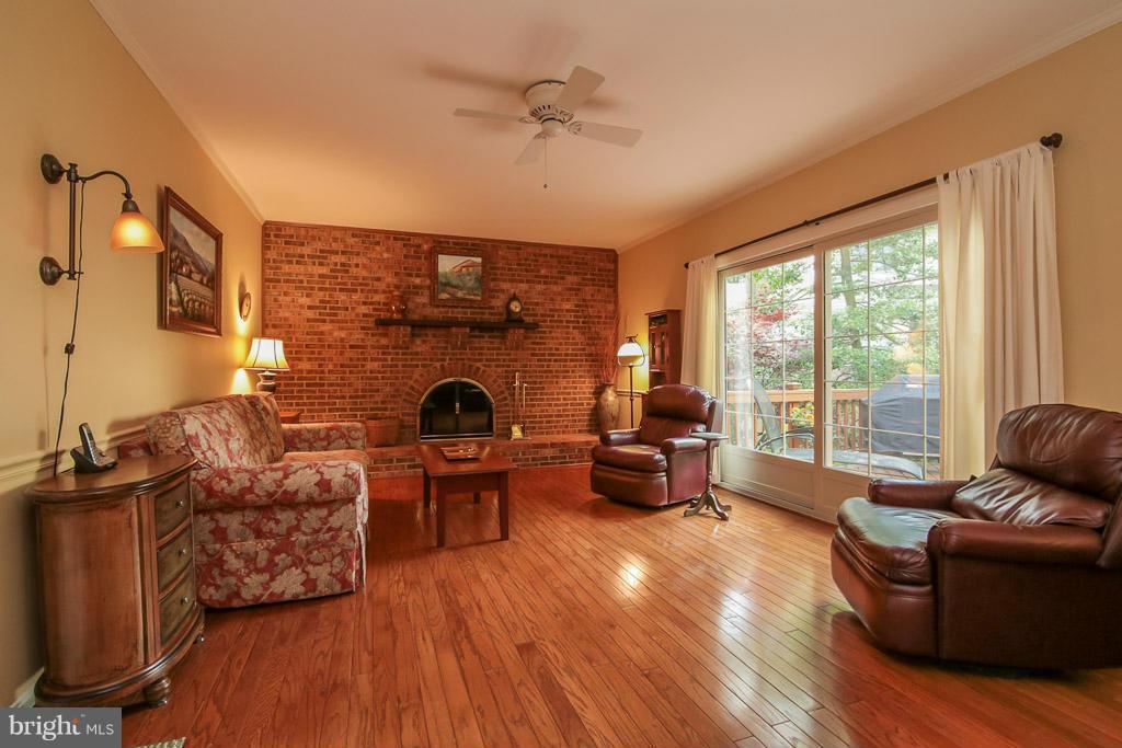9913 Natick Road Burke, VA 22015 - Photo 11 of 30 Arched wood burning FP on brick wall;deck access