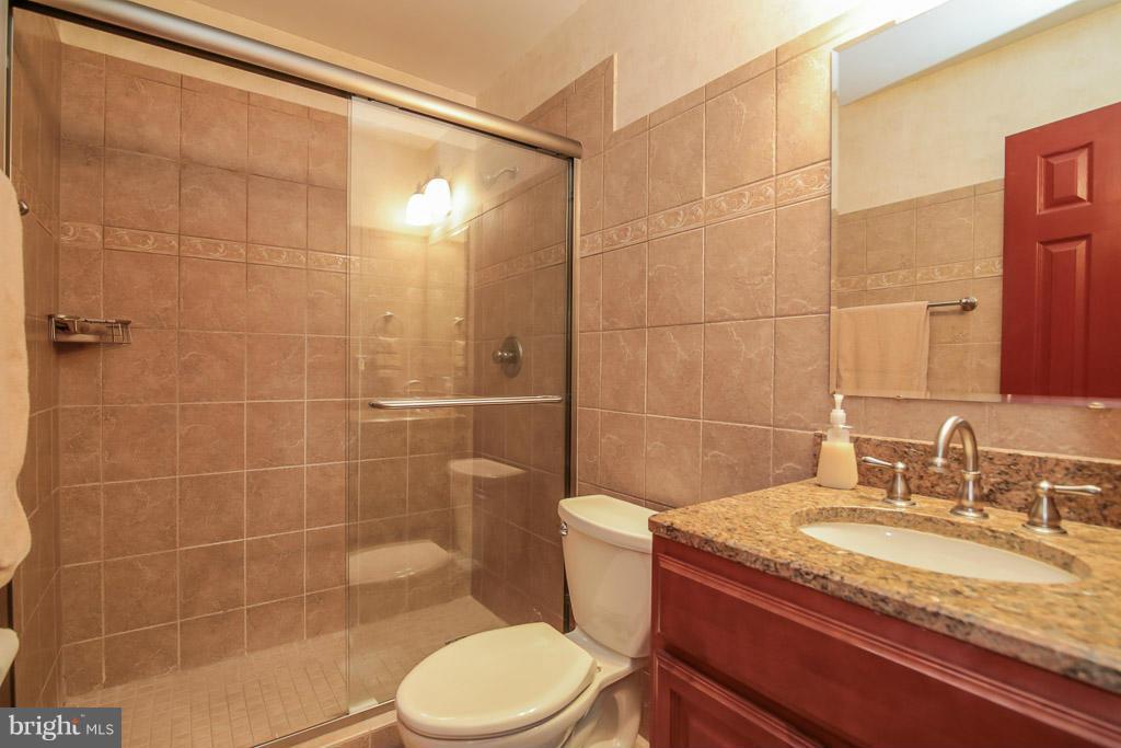 9913 Natick Road Burke, VA 22015 - Photo 17 of 30 Updated-frameless ceramic tiled shower,granite