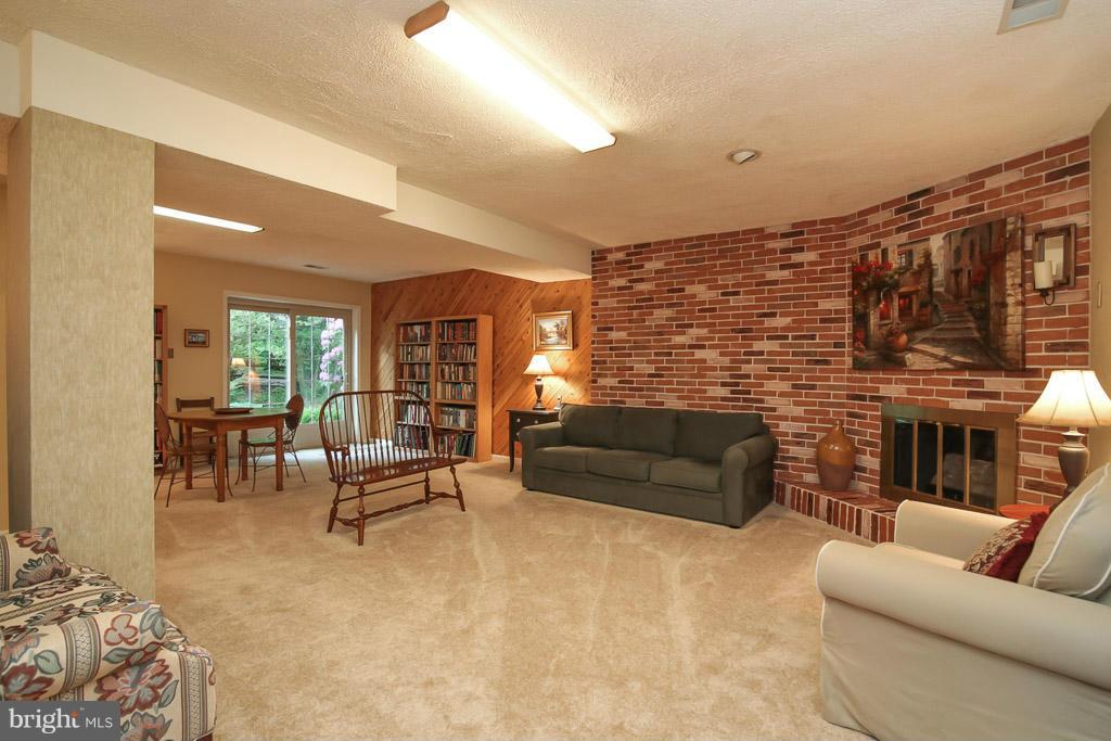 9913 Natick Road Burke, VA 22015 - Photo 24 of 30 Huge rec room w/walkout, electric FP on brick wall
